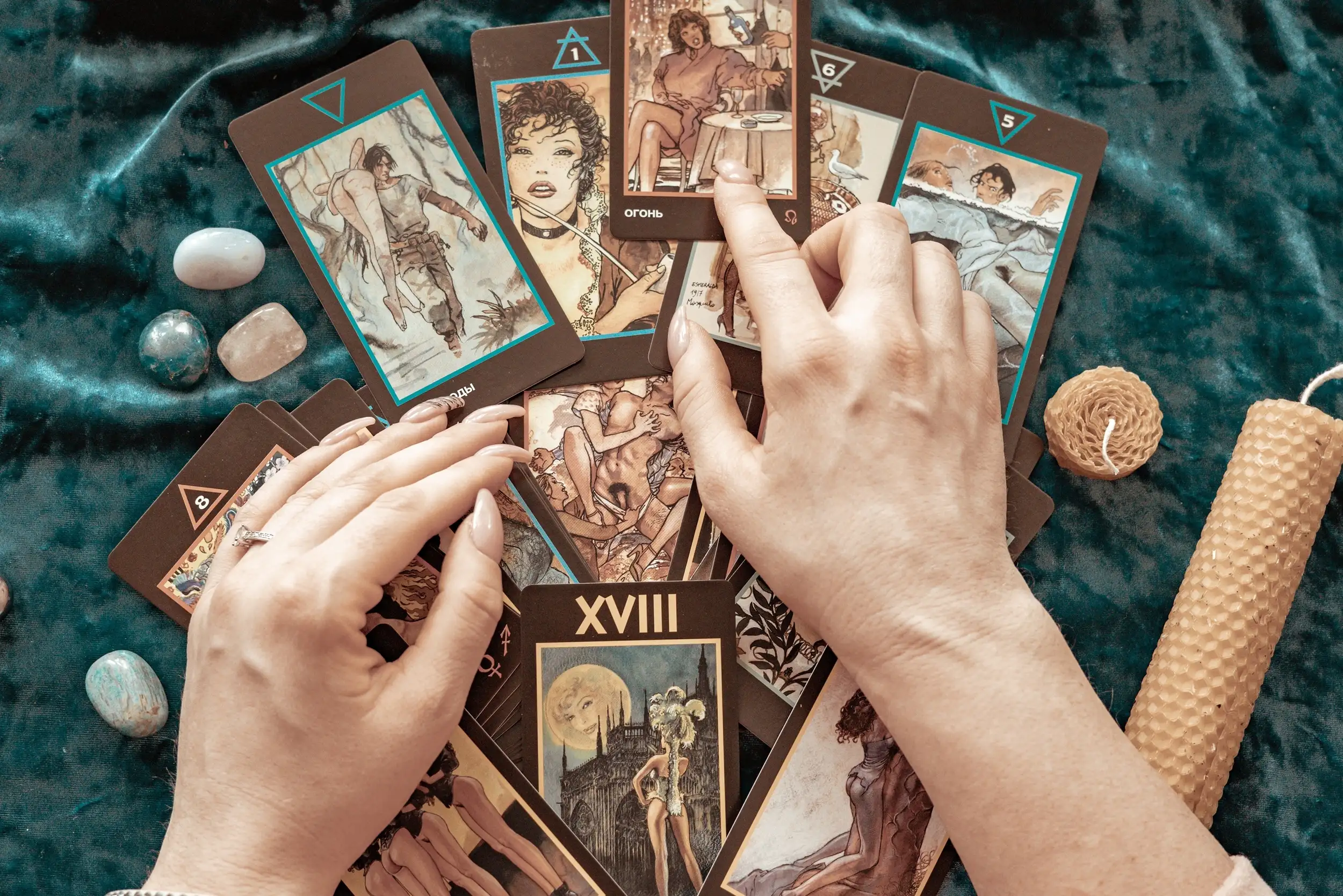 Top view of a hands with tarot cards laid in a table.