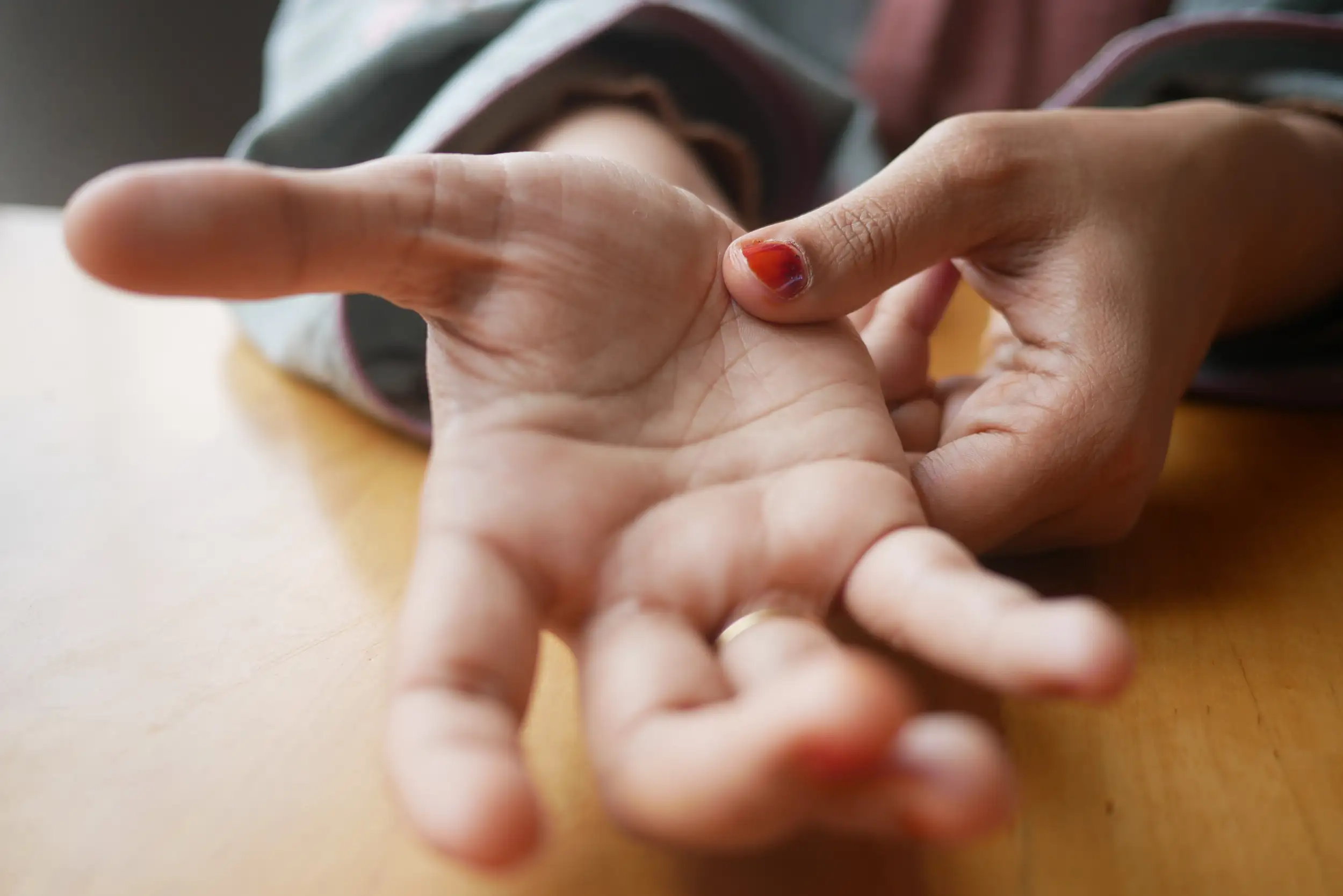 A hand reaching on the camera.